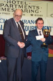 Mikhail Ulibin receives his prize from Patrick Taylor